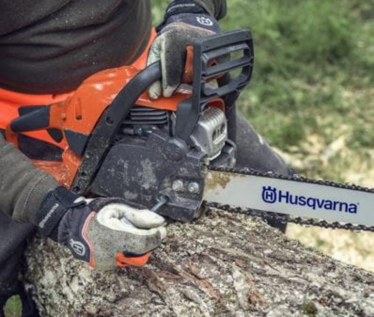 Husqvarna 135 Mark II Chainsaw 14” pictured being used to cut a log