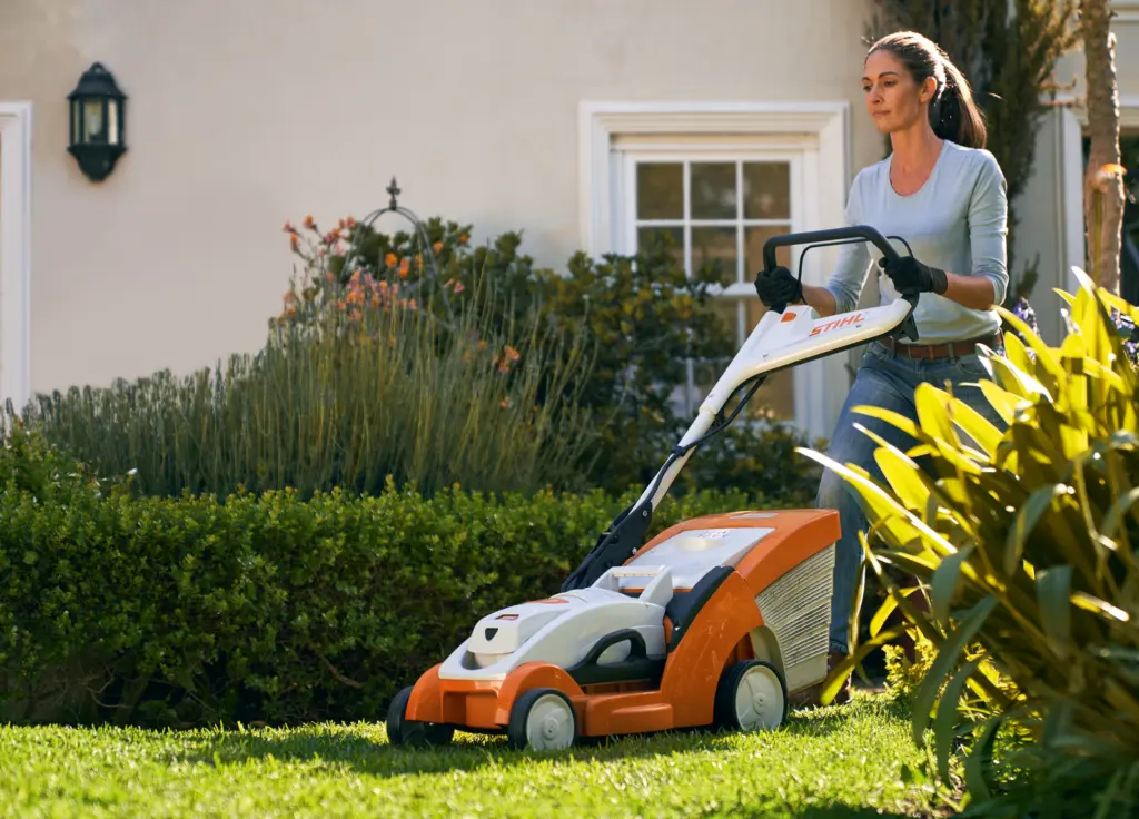 woman pushing her lawnmower