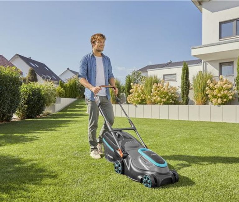 man pictured mowing his lawn with his Gardena Battery Lawnmower PowerMax 37