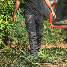 Arbortec AT4070 Breatheflex Pro Chainsaw Trousers Design C Class 1 pictured being worn by a workman in a forest in black