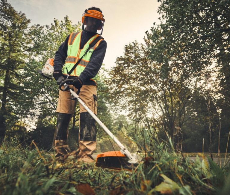 Stihl KMA 200 R Cordless KombiMotor – AP System pictured being used by a man in full PPE to cut a lawn