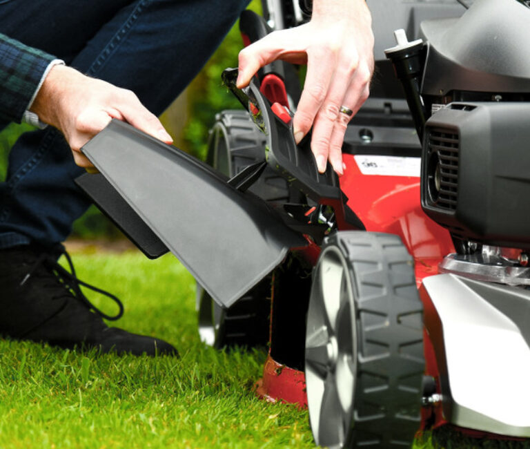 Cobra MX460SPC 18” S/P Lawnmower Powered by Cobra pictured having adjustments done showing how easy it is